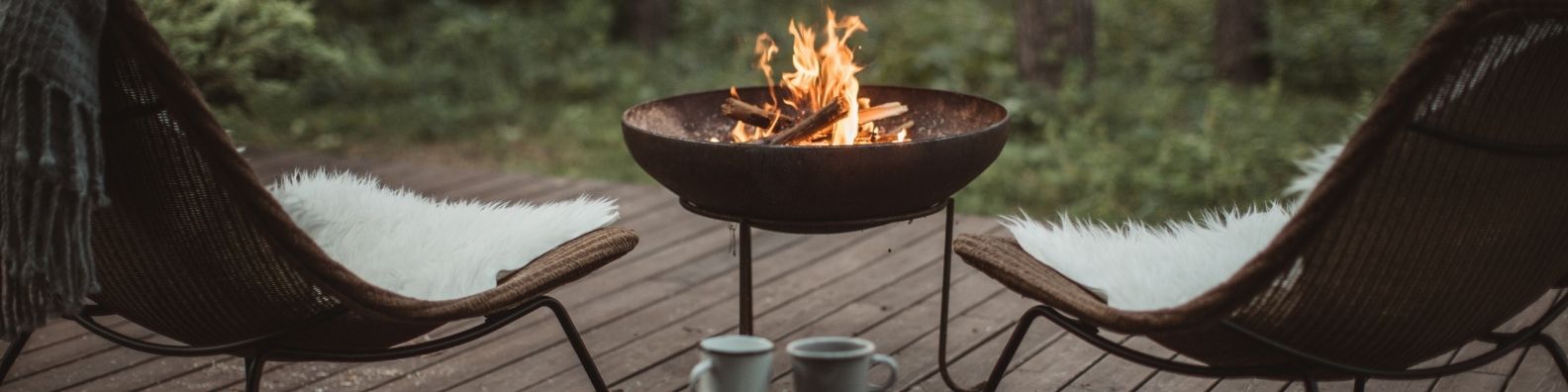 Fire pit on a timber deck of an off grid holiday cabin
