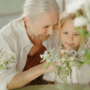 granny and child looking at flowers